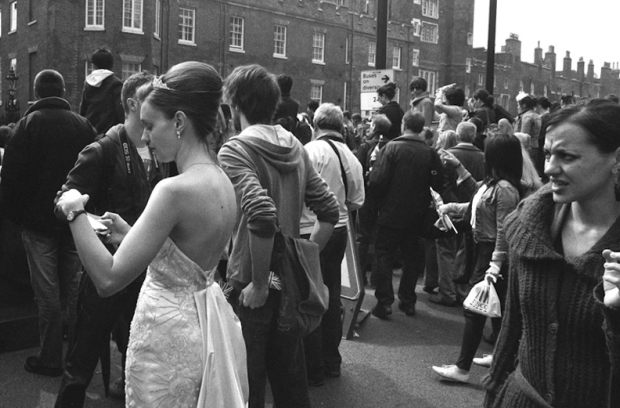In front of St James's Palace, a woman dressed for the occasion In front of St James's Palace, a woman dressed for the occasion
